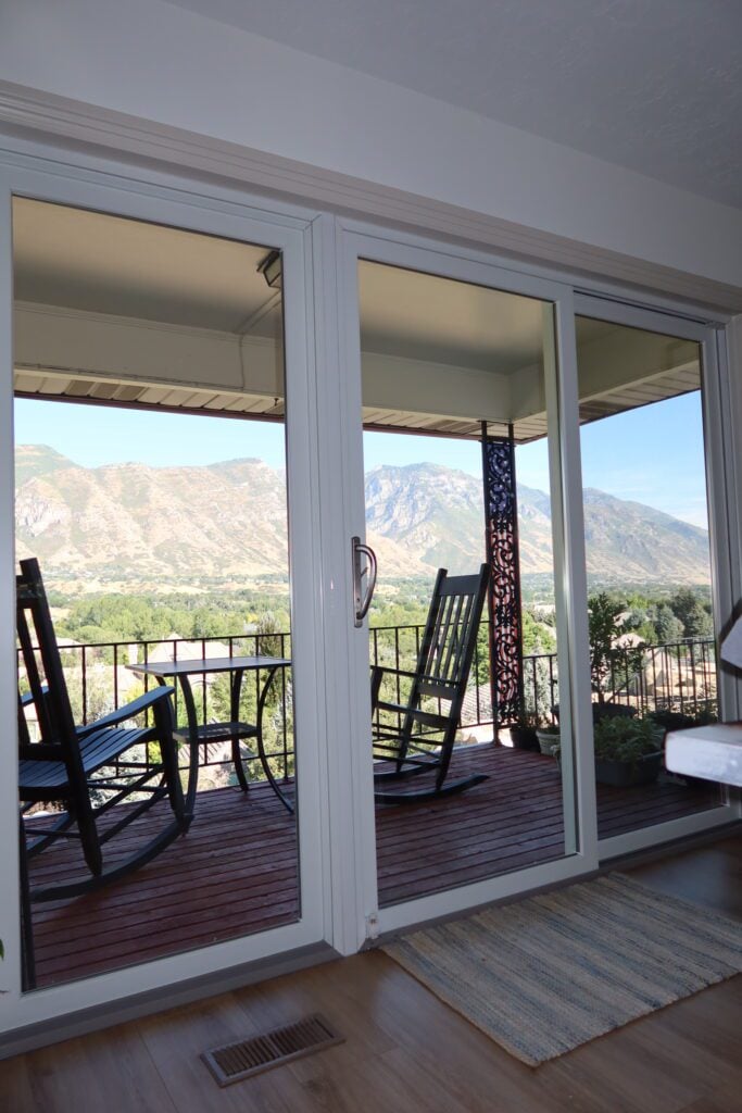 Sliding glass door by JDI Windows, showcasing a modern design with clear glass and sleek frames.